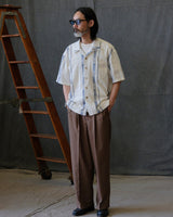 High-waisted pleated wool-blend trousers