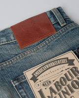 Distressed Redline Selvedge Jeans in vintage wash – close-up of leather patch