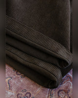 Double-pleated Corduroy Trousers in dark brown – close-up of corduroy hem